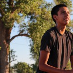 Shane Yazzie, junior guard at Chinle High School, shooting baskets behind his house. (Photo by Chris Wimmer/Cronkite News)