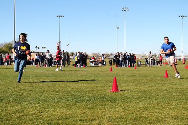 Camp participants run drills around cones as Cardinals safety Tyrann Mathieu looks on. Photo by Miranda Perez