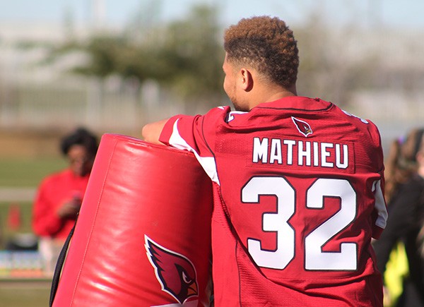 Cardinals safety Tyrann Mathieu stands by and watches intently as students participate in a variety of drills. Photo by Miranda Perez