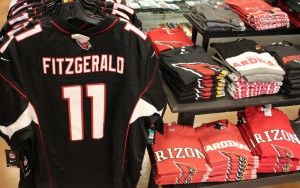 An Arizona Cardinals Larry Fitzgerald jersey hangs on a rack at the Just Sports store inside Chandler Fashion Center. Fitzgerald's jersey is the team's best seller, according to the team. 