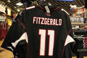 An Arizona Cardinals Larry Fitzgerald jersey hangs on a rack at the Just Sports store inside Chandler Fashion Center. Fitzgerald's jersey is the team's best seller, according to the NFL Players Association.