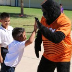 The Phoenix Suns Gorilla high fives a student at Loma Linda Elementary. (Cronkite News photo by Kevin Jimenez)