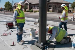 Workers construct a portion of the light rail line near 19th and Montebello avenues. (Cronkite News photo by Amy Edelen)