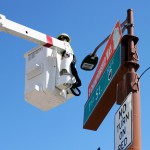 Crews outside US Airways Center on Friday, Sept. 11, 2015, install a “3 Championship Way” street sign atop First St. at East Jefferson St. The Mercury enter the playoffs as the No. 2 seed, looking for their fourth title. (Cronkite News photo by Evan Webeck)