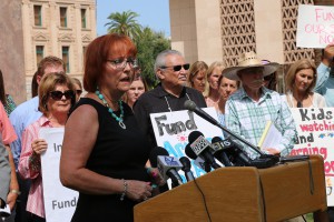 Jennifer Johnson, executive director of Support Our Schools AZ, addresses a news conference at which advocates called for a special legislative session to provide hundreds of millions of additional funding courts have ordered.