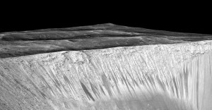 Dark streaks on the walls of Garni crater on Mars are believed to be caused by briny liquid water, researchers reported Monday, Sept. 28, 2015. (Photo by NASA/JPL/University of Arizona)