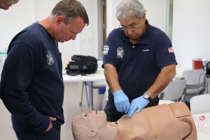 Phoenix Fire Department Capt. David Sanchez, right, and Capt. Scott Petersen practice needle decompression on a mannequin in the Center for Simulation and Innovation lab at the University of Arizona College of Medicine- Phoenix. The technique is used to reinflate a collapsed lung.