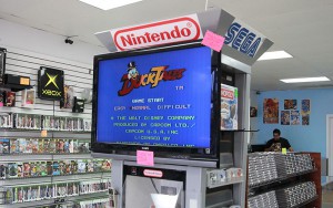 The sign on this games advises customers to “please be gentle” with this retro video game at Flashback Games in Tempe. (Photo by Lynnie Nguyen/Cronkite News) 
