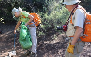 Jean Ober, a volunteer from Friends of the Forest, picks up trash left by visitors of Fossil Creek.