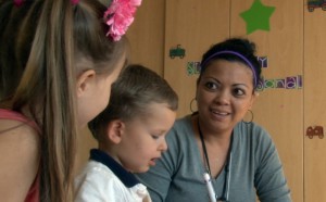 Gigi Elliott, a child life specialist at the Phoenix Children's Hospital, plays with Savannah and Blake Johnson. Their sister is awaiting a heart transplant. (Photo by Yahaira Jacquez/Cronkite News)