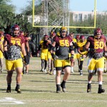 (Left to right) Seniors Vi Teofilo, Christian Westerman and Nick Kelly warm up during a practice before their final game at Sun Devil Stadium Saturday against the Arizona Wildcats. (Photo by Bill Slane/Cronkite News)