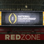 The College Football Playoff National Championship game logo is shown on the scoreboard at University of Phoenix Stadium. The venue will host the game on Jan. 11. (Photo by Kris Vossmer/Cronkite News)