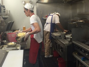 Chefs at Glendale’s Loving Hut restaurant cut potatoes and tofu in preparation for vegan meals. (Photo by Lauren Clark/Cronkite News)