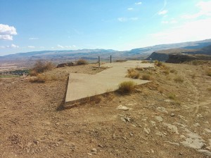 Remnants of Transcontinental Air Mail Route Beacon 37A, atop a bluff in St. George, Utah, with concrete arrow indicating the direction to the next beacon. (Photo courtesy of Dppowell via Wikimedia Commons)