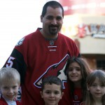 Kevin Armijo of Avondale (center) traded in his Colorado Avalanche jersey to get his daughter a new Coyotes jersey. (Zuriel Loving/Cronkite News)