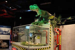 A “Jurassic Park” egg incubator simulator is topped with a roaring dinosaur at the Arizona Science Center in the POPnology exhibit in Phoenix. (Photo by Kaitlyn Thompson/Cronkite News)