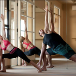 Bikram Yoga Tempe owners Ben and Elaina Zorensky practice at their studio. (Photo courtesy Bikram Yoga Tempe) 