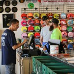 Keith Murray, left, owner of Spinners on the Green in Scottsdale, helps two customers before a weekly doubles competition at Vista del Camino Park. (Photo by Rian Bosse/Cronkite News)