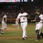 Arizona Diamondbacks right-handed relief pitcher Jake Barrett comes off the mound with his battery mate Wellington Castillo after a scoreless fifth inning Monday. (Photo by Kris Vossmer/Cornkite News)