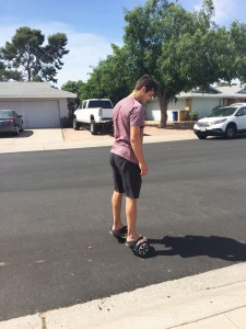 Jordan Masters, an Arizona State University student, sells hoverboards for VBoards. He said business has slowed dramatically. (Photo by Zac Pacleb/Cronkite News)