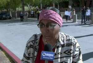 Sylvia Herrera, member of the Barrio Committee, helps families protest.