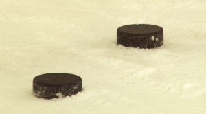 Hockey pucks are made of vulcanized rubber and very heavy as a result. (Blake Benard/Cronkite News)