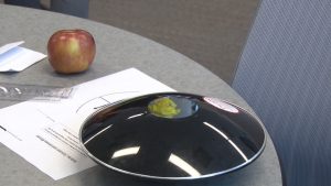 Professors from Vietnam are trying to create a hologram product similar to this one using an apple, mirrors, lenses, and paper. The professors are part of the Higher Engineering Education Alliance Program at Arizona State University. (Photo by Eddie Keller/Cronkite News)