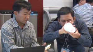 Two professors from Vietnamese universities are participating in an exercise as part of the Higher Engineering Education Alliance Program at Arizona State University. (Photo by Eddie Keller/Cronkite News)