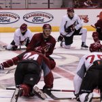 Prospects stretch after their ice session at the Coyotes development camp at Gila River Arena. (Photo by John Alvarado/Cronkite News)