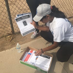 Rosa Pastrana sorts through the silent witness flyers they will be passing out to Maryvale neighbors. (Photo by Selena Makrides/Cronkite News)