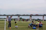 Calai Hern‡ndez (third from right) watches her sonÕs soccer team practice at Shelby Park in Eagle Pass. Behind them is the International Bridge that connects Eagle Pass Texas to Piedras Negras, Coahuila.