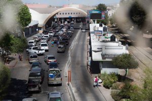 People wait to cross the border in Nogales, Sonora to Nogales, Arizona. (Photo by Courtney Pedroza/Cronkite News)