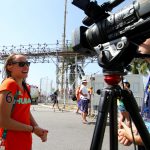 Ryan Curry interviews ASU swimmer Anna Olasz after her 10K open water swimming event at Copacabana Beach. (Photo by Scotty Bara/Cronkite News)