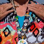 Judi Brandt wears her newest Olympics pins on a lanyard. When they return, the pins will be on display in their home with others from previous games. (Photo by Courtney Pedroza/Cronkite News)