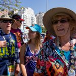 Judi Brandt (right) speaks to an Olympic official while in line for a beach volleyball match in Rio de Janeiro. Her family behind her, Chuck, Eric and Sydney Brandt (from left to right) wait to enter. (Photo by Courtney Pedroza/Cronkite News)
