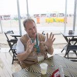 Larry Slater talks about photography at Copacabana Beach in Rio de Janeiro, Brazil on Aug. 12, 2016. (Photo by Jaclyn Chung/Cronkite News)