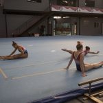 Ashton Locklear, MyKayla Skinner and Ragan Smith (left to right) stretch at the Flamengo Club in Rio de Janeiro, Brazil on Aug. 5, 2016. (Photo by Jaclyn Chung/Cronkite News)