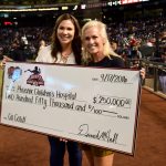 Amy Goldschmidt holds up the $250,000 check presented to Phoenix Children’s Hospital on behalf of the Arizona Diamondbacks Foundation and Goldy’s Fund 4 Kids. (Photo by Giselle Cancio/Cronkite News)