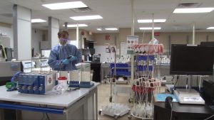 A United Blood Services worker separates plasma and blood in a lab. (Photo by Samantha Witherwax/Cronkite News)