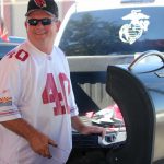 Cardinals fan Brad Hendrix grills bacon-wrapped filet mignon cuts before the home opener against the New England Patriots, Sunday, Sept. 11 at University of Phoenix Stadium. (Photo by Nicole Vasquez/Cronkite News)