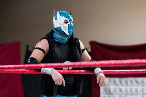 Ave Dragon stands on the ring apron before the beginning of a lucha libre match. (Photo by Christopher West/Cronkite News)