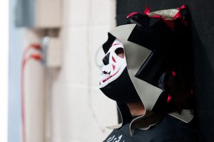 A masked spectator watches on at a lucha libre show in Glendale put on by P.o.r. Promotions. (Photo by Christopher West/Cronkite News)