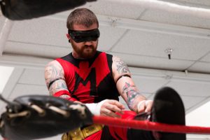 Shane Marvel checks his gear before a match in downtown Phoenix. While still a niche form of entertainment, lucha libre has a growing following in the Valley. (Photo by Christopher West/Cronkite News)