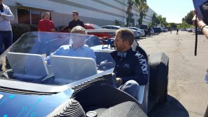 Steve Case (left) and Local Motors CEO John B. Rogers Jr. take a spin in a 3-D printed car. (Photo by Gavin Maxwell/Cronkite News)