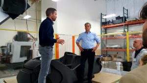 Steve Case (right) and Local Motors CEO John B. Rogers Jr. discuss the Phoenix company's production methods. (Photo by Gavin Maxwell/Cronkite News)