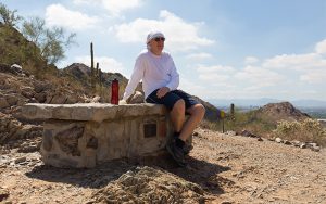 Stephen Nally takes a break on the Nature Trail in the Phoenix Mountain Preserve on Sept. 8. (Photo by Ryan Dent | Cronkite News)