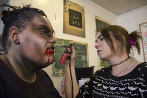 Makeup artist Cyra Reed (right) applies makeup to Brianna Lally at Fear Farm in the West Valley. (Photo by Ally Carr/Cronkite News)