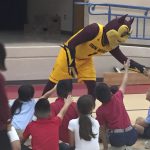 ASU mascot Sparky shakes hands with third-graders from Aguilar Elementary School before an event for Read to the Final Four on Thursday. (Photo by Ryan Decker/Cronkite News)