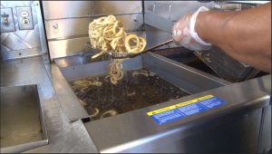 After a couple days of being used to make Piggly Fries, the vendor takes the oil from the deep fryer to be recycled into fuel. (Photo by Natalie Tarangioli/Cronkite News)