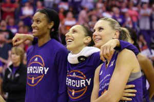 Phoenix Mercury players DeWanna Bonner, Diana Taurasi and Penny Taylor enjoy one of their final moments on the court together during Taylor's last regular season home game on Sept. 15. (Photo by Lindsey Wisniewski/Cronkite News)